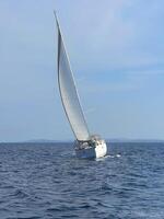 a sailboat sailing in the open ocean photo