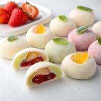 Korean style mochi with fruit filling, arranged neatly., isolated on a white background photo