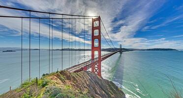 Golden Gate Bridge with blue sky and scenic ocean view from a high vantage point sa photo