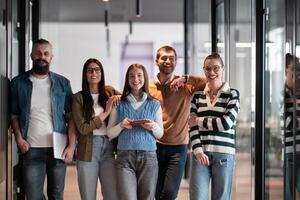 A diverse team of professionals in a modern coworking startup office smiles together, showcasing teamwork, collaboration, and a positive corporate culture that promotes innovation and a dynamic work photo