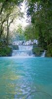 Scenic cascade waterfalls with blue water in Central Sulawesi, vertical view video