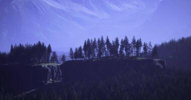 Majestic landscape with trees on cliff under smooth blue sky at dusk video