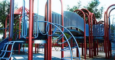 Colorful playground structure in a park on a sunny day video