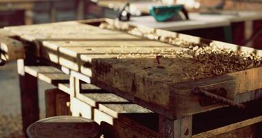 Woodworking bench with wood shavings in a bright workshop setting video