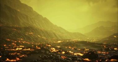 Lava flows illuminate a surreal landscape under a yellow sky video