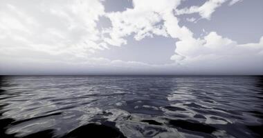 Peaceful ocean surface reflecting clouds in a serene atmosphere video