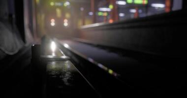 Subway platform view showcasing train lights in dim setting during evening video
