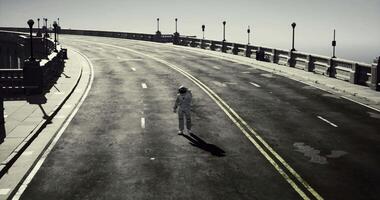 Astronaut walking alone on a deserted road in a surreal setting video