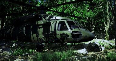 Military helicopter parked in a dense forest during daytime operations video