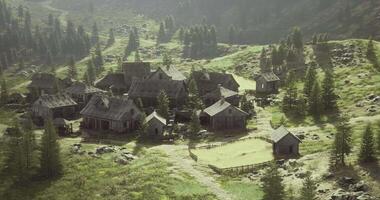 Rustic village nestled in mountainous landscape surrounded by lush trees video