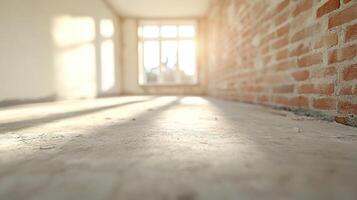 Sunlight streams into a large room with unfinished features, casting shadows on the bare concrete floor photo