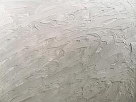 Rough textured gray background with a pronounced plaster texture. Ideal for backgrounds, interior design, graphics, and packaging photo