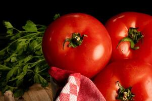 Fresh Ripe Tomatoes with Parsley on Rustic Kitchen Setting photo