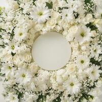 Top down view of an empty podium surrounded by white funeral flowers in a serene setting.0000000q photo