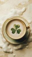 Cup of coffee with a clover leaf design on creamy foam, good luck, St. Patrick's Day photo