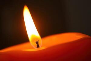 Hyperrealistic macro closeup of a glowing candle flame with melting wax in warm orange tones serene and peaceful atmosphere perfect for meditation relaxation and spiritual concepts photo