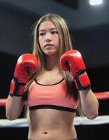 A young woman in a boxing ring photo