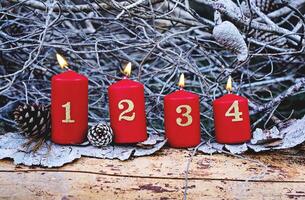 Four red advent candles with number as Catholic symbol of Christmas. Christmas decoration with burning candles for advent time photo