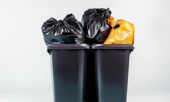 Three black trash cans with orange and black bags photo