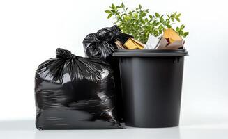 Garbage can with black garbage bags and plant photo