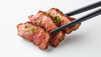 Chopsticks with meat on them on a white background photo