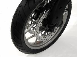 Front wheel of modern motorcycle isolated on white background photo