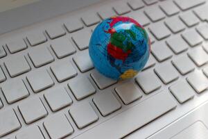 Globe Model On Blank Computer Keyboard Stock Photo. International Communication Concept Stock Image photo