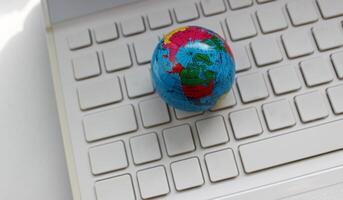 Small Globe On Empty Keyboard Keys Conceptual Photo For Illustration Global Business Or International Communication