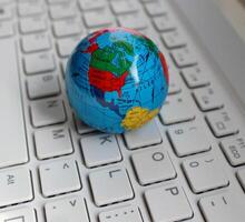 North America Continent Between Oceans Is Mapped On Small Globe On Computer Keyboard photo
