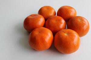 Flower Shaped Ripe Mandarins Lying On Clean White Surface Angle View photo
