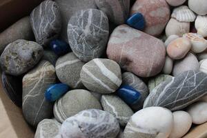 Pattern Of Blue Quartz Stones On A Mix With Sea Pebbles And Granite Stones With Veins photo