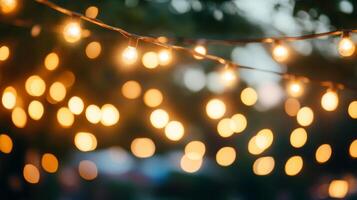 Warm ambient light created by hanging string lights at evening event photo