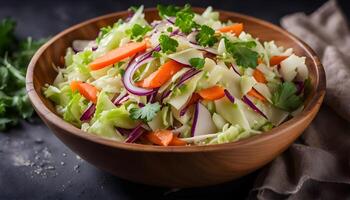 Cabbage salad. Homemade salad of cabbage, carrots and apples in a wooden bowl on a dark background. Vegan or diet food. photo