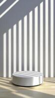 White Cylindrical Podium in Sunlit Room photo