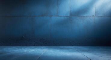 An empty room with blue walls and a light coming from the ceiling photo