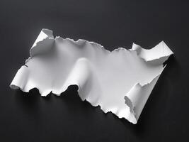 A piece of paper with torn edges on a black surface photo