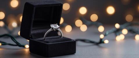 an engagement ring in a box with lights in the background. photo