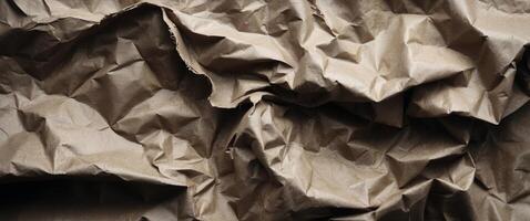 Crumpled brown paper texture with wrinkles and folds photo