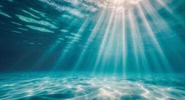 Underwater light beams shining through the water photo