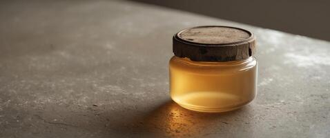 Honey Jar Resting on Granite Table with Soft Glow photo