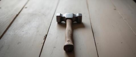 there is a hammer that is on top of a table photo