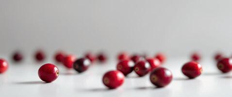 Fresh cranberries arranged on a clean white surface photo