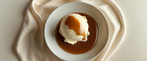 A bowl of ice cream with caramel sauce on top photo