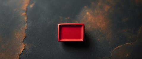 A red square on a black surface photo