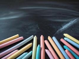 Colorful chalk on blackboard background photo