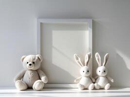 Three stuffed animals and a blank frame on a white table photo