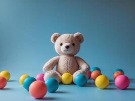 Soft Toy and Colorful Balls on Blue Background photo