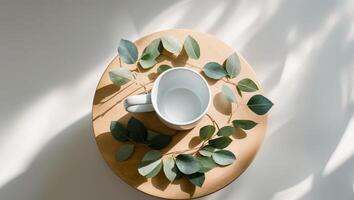 Top View of a Simple White Mug on a Wooden Table with Decorative Leaves. photo