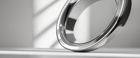 A ring is sitting on a table in front of a window photo