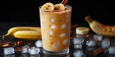Refreshing banana smoothie with ice and spices served on a dark background photo